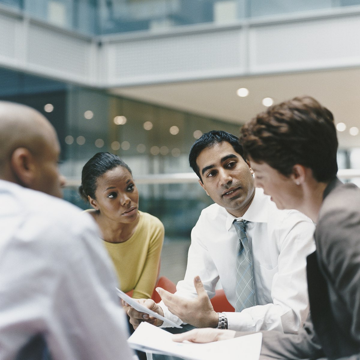 A diverse group of employees sitting around a table.